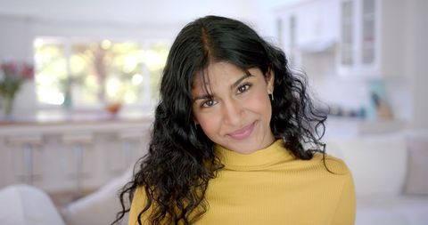 Smiling Biracial Teen at Home with Curly Hair