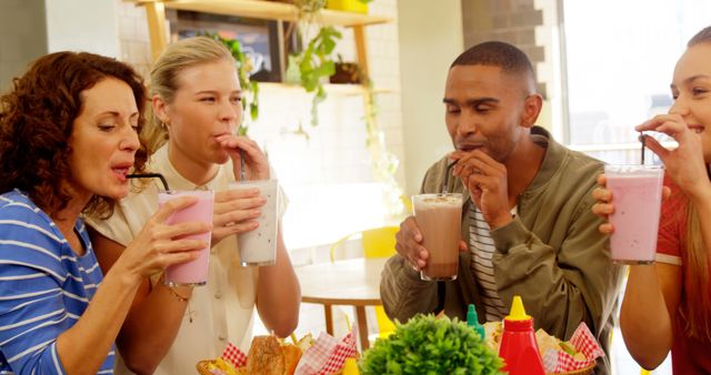 Group of Friends Enjoying Milkshakes at Cafe Table - Download Free Stock Images Pikwizard.com