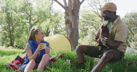 Diverse Couple Camping Playing Guitar in Outdoor Park Setting - Download Free Stock Images Pikwizard.com