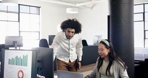 Colleagues Engaging in Lively Discussion in Modern Office Space