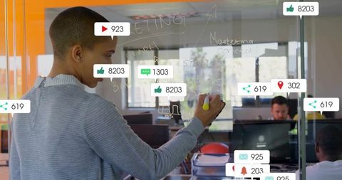 Woman Planning Marketing Strategy on Office Glass Board