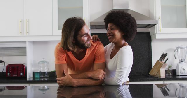 Portrait of biracial couple smiling in the kitchen at home. staying at home in self isolation in quarantine lockdown