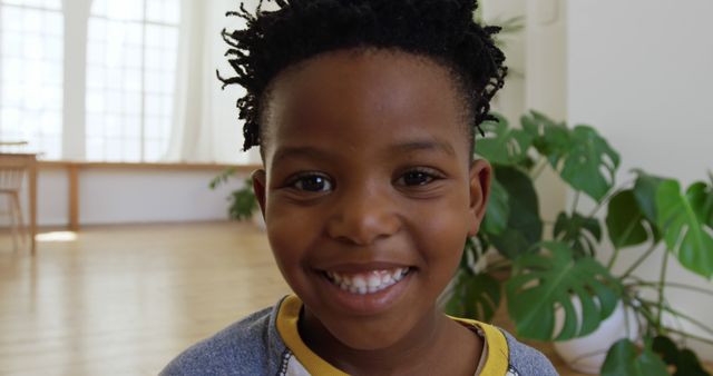 Smiling Young Boy with Bright Expression in Sunny Room - Download Free Stock Images Pikwizard.com