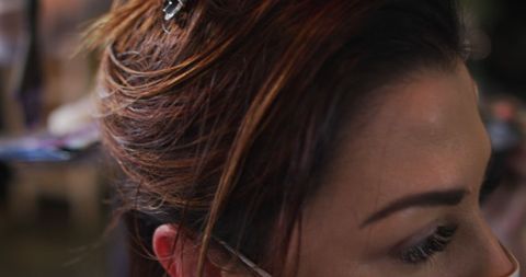 Close-Up of Stylist's Hands Dyeing Client's Hair at Salon