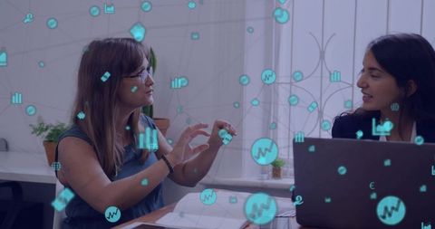 Two women collaborating with augmented analytics icons over laptop, presenting data