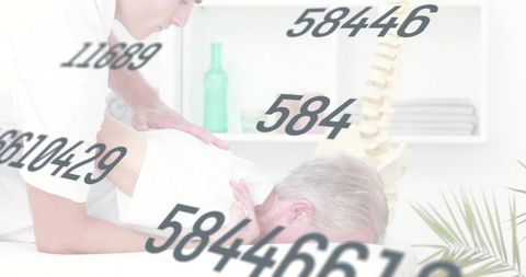 Chiropractor performing manual back therapy on senior patient with spine model in clinic
