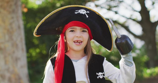Young Girl Dressed as Pirate Waving Toy Hook in Park - Download Free Stock Photos Pikwizard.com