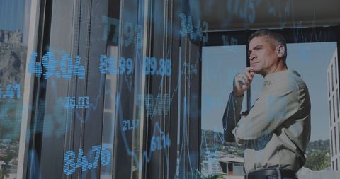 Businessman Contemplating Financial Data in Office Environment