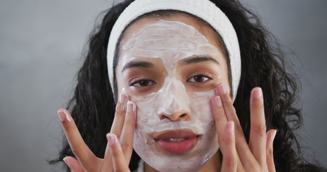 Woman applying face mask and relaxing with skincare routine - Download Free Stock Images Pikwizard.com