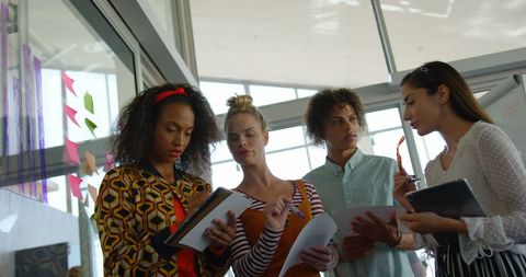 Diverse Team Collaborating with Digital Devices and Documents