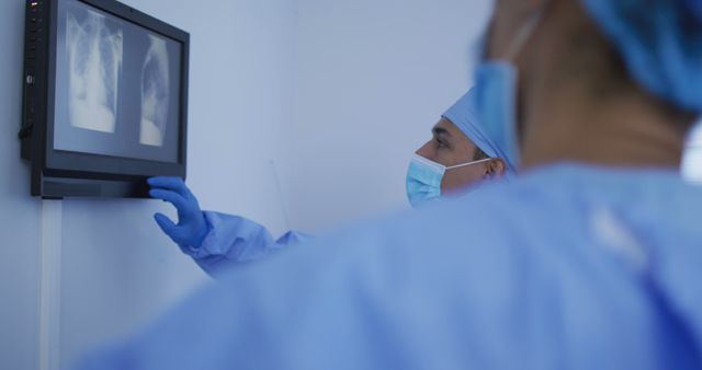 Healthcare Professionals Analyzing X-Ray Images on Screen in Medical Facility - Download Free Stock Images Pikwizard.com