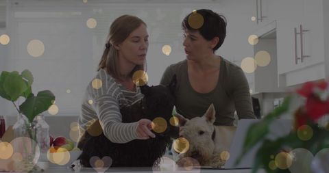 Same-Sex Female Couple Enjoying Time with Pets in Modern Kitchen