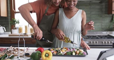 Joyful Couple Cooking Together in Home Kitchen