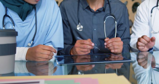 Medical Team Discussing Patient Data on Tablet in Meeting - Download Free Stock Images Pikwizard.com