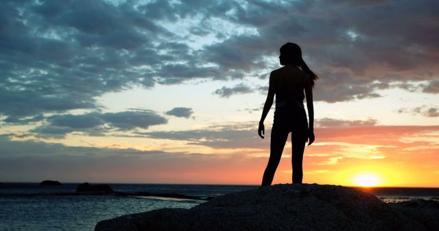 Silhouette of Woman Standing on Rock During Sunset by Ocean - Download Free Stock Images Pikwizard.com