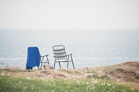 Tranquil seaside chairs overlooking ocean horizon