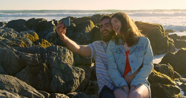 Happy couple taking selfie on rocky beach - Download Free Stock Images Pikwizard.com