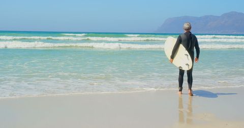 Senior Surfer with Surfboard Gazing at Ocean Horizon - Download Free Stock Images Pikwizard.com
