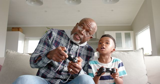 Grandfather and Grandson Bonding While Playing Video Games at Home - Download Free Stock Images Pikwizard.com