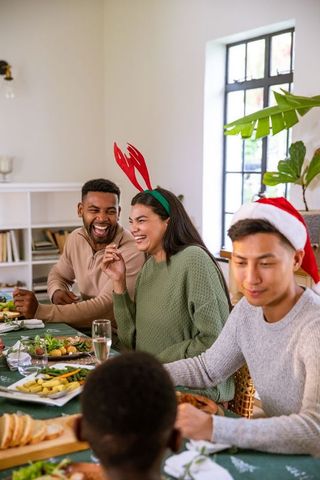 Joyful Diverse Friends Celebrating Christmas Dinner