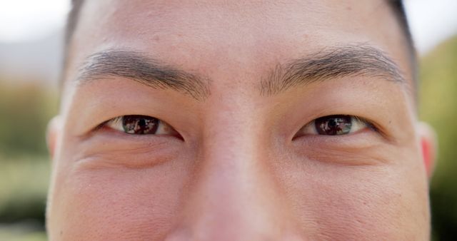 Eyes of happy asian man standing and smiling in sunny garden - Download Free Stock Photos Pikwizard.com