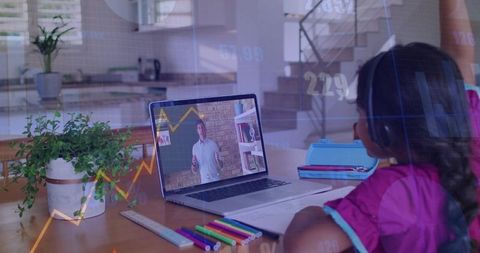 Child Attending Remote Lesson at Home Desk with Laptop, Headphones, Notebooks, Colorful Pens