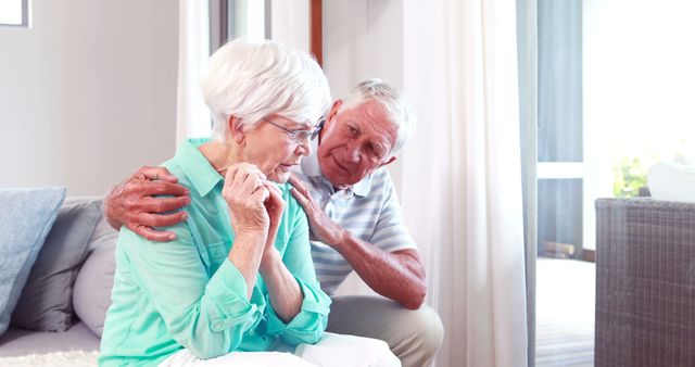 Caring Elderly Man Comforting Upset Elderly Woman Sitting in Living Room - Download Free Stock Images Pikwizard.com