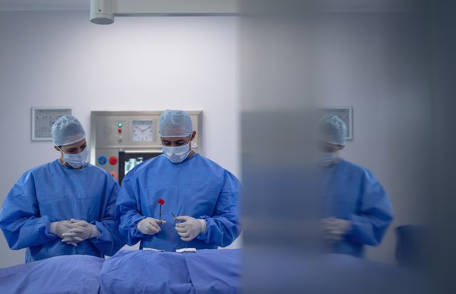 Surgeons performing surgery in operation theater at hospital