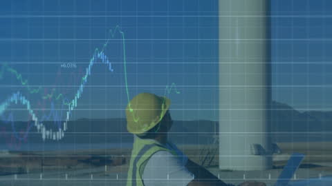 Engineer Analyzing Financial Data with Wind Turbine Background