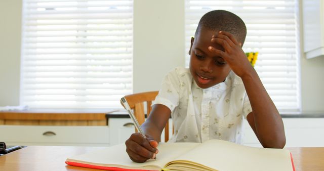 African American Boy Writing in Notebook at Home - Download Free Stock Images Pikwizard.com