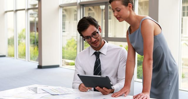 Business Colleagues Reviewing Data on Digital Tablet in Modern Office - Download Free Stock Images Pikwizard.com