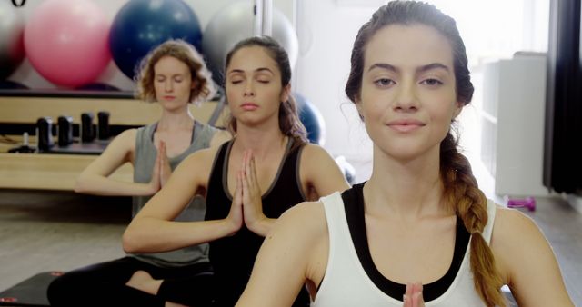 Group Yoga Class with Three Women Meditating at Studio - Download Free Stock Images Pikwizard.com