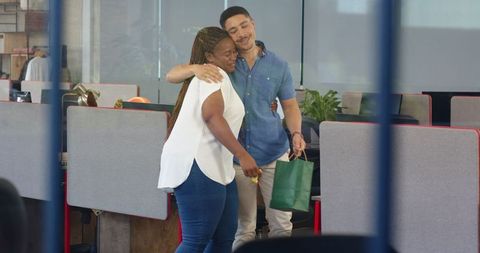 Office Celebration Scene with Warm Embrace and Gift Exchange