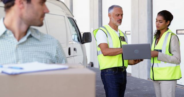 Warehouse Workers Using Laptop for Inventory Management Near Delivery Van - Download Free Stock Images Pikwizard.com