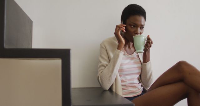 Woman Drinking Coffee and Talking on Phone at Home - Download Free Stock Images Pikwizard.com