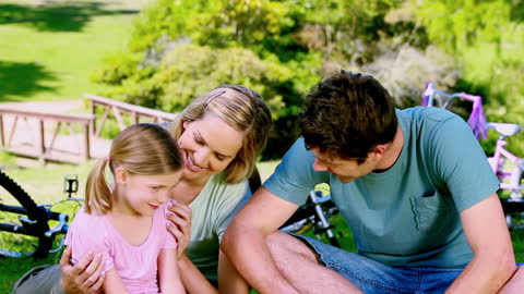 Family Enjoying Time Together with Bicycles at Park