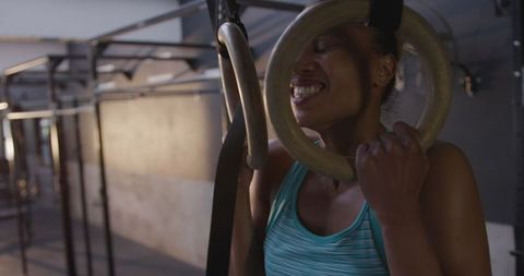 Empowered Athletic Woman Lifting on Gym Rings