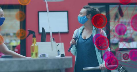 Masked woman engaging in social interaction with digital interface