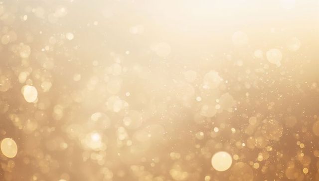 Shimmering golden bokeh backdrop featuring soft glowing glitter and light orbs