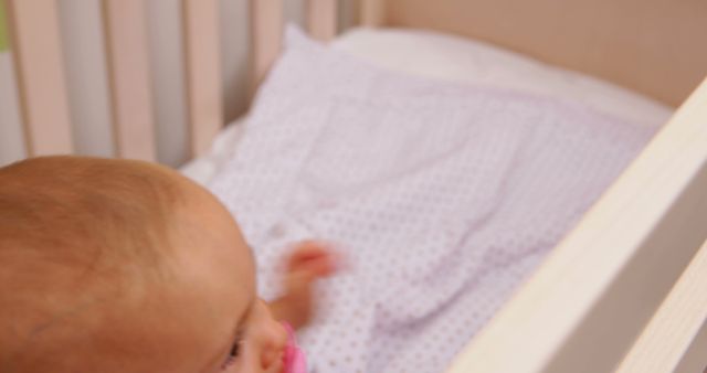 Close-Up of a Baby Girl In a Crib With Pink Pacifier - Download Free Stock Images Pikwizard.com