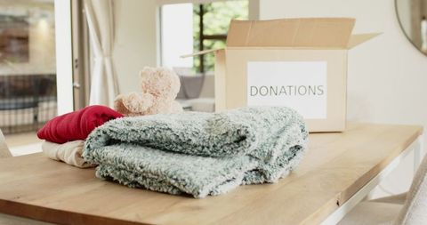 Charitable Donations with Soft Textiles on Wooden Table