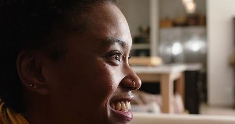 Joyful African American Woman Sitting in Modern Kitchen