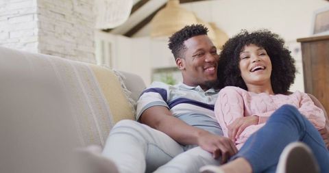 Joyful African American Couple Relaxing on Couch