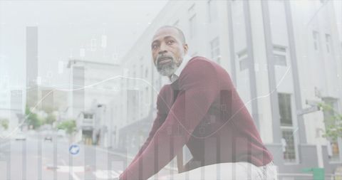 African American Businessman Cycling with Abstract Financial Overlay - Download Free Stock Images Pikwizard.com
