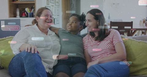Laughing parents and child on sunlit sofa with social media overlays for family lifestyle