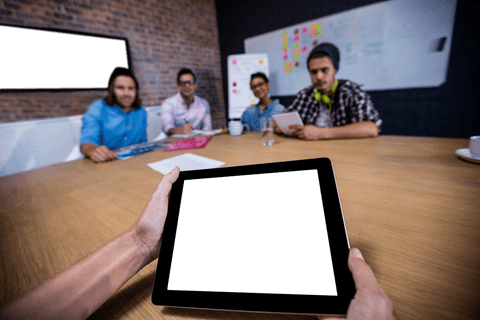 Transparent tablet display in collaborative office meeting scene