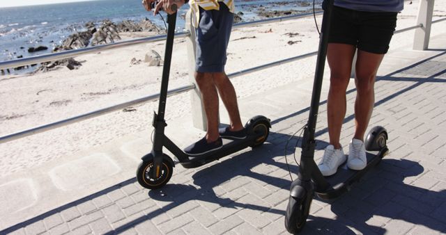 Two People Riding Electric Scooters by Beachfront Promenade - Download Free Stock Images Pikwizard.com