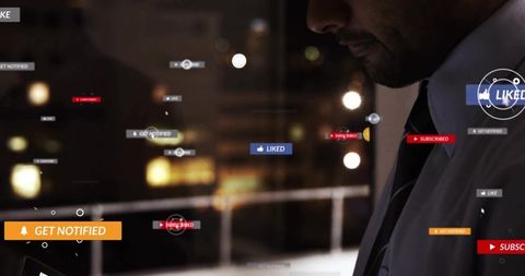 Asian businessman studying tablet with social media notifications overlay at night