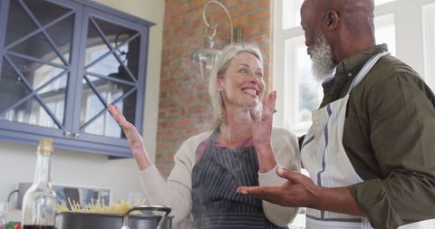 Joyful Senior Couple Cooking Together at Home