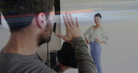 Photographer directing model in studio using dslr, posing guidance, softbox lighting